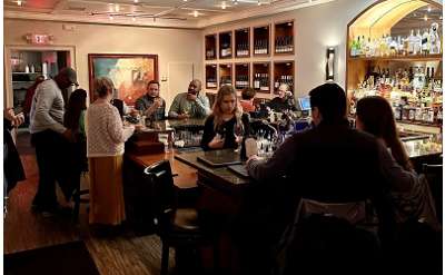 people sitting inside of a wine bar
