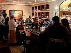 people sitting inside of a wine bar