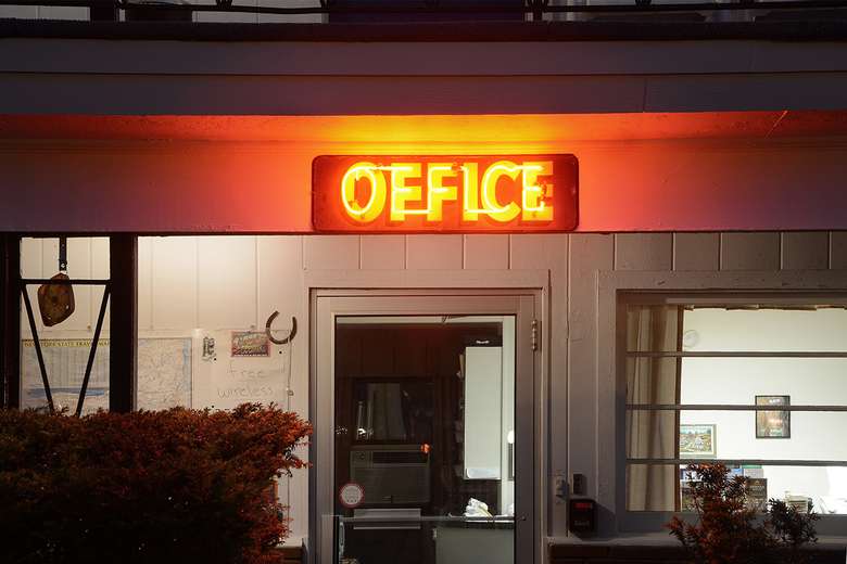 neon office sign above the entrance to the turf and spa motel's office