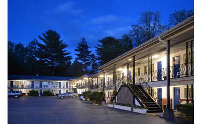 exterior of the two-story turf and spa motel at night