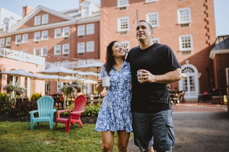 man and woman walking around a hotel property