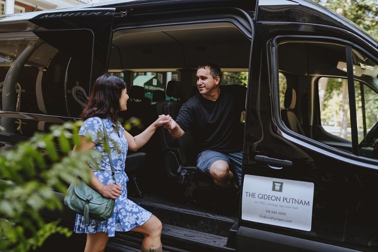 man and woman getting into a shuttle car