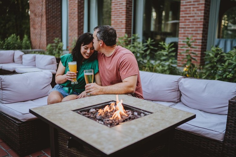 man and woman embracing on lounge chair
