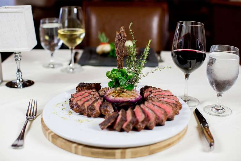 artfully plated steak with wine