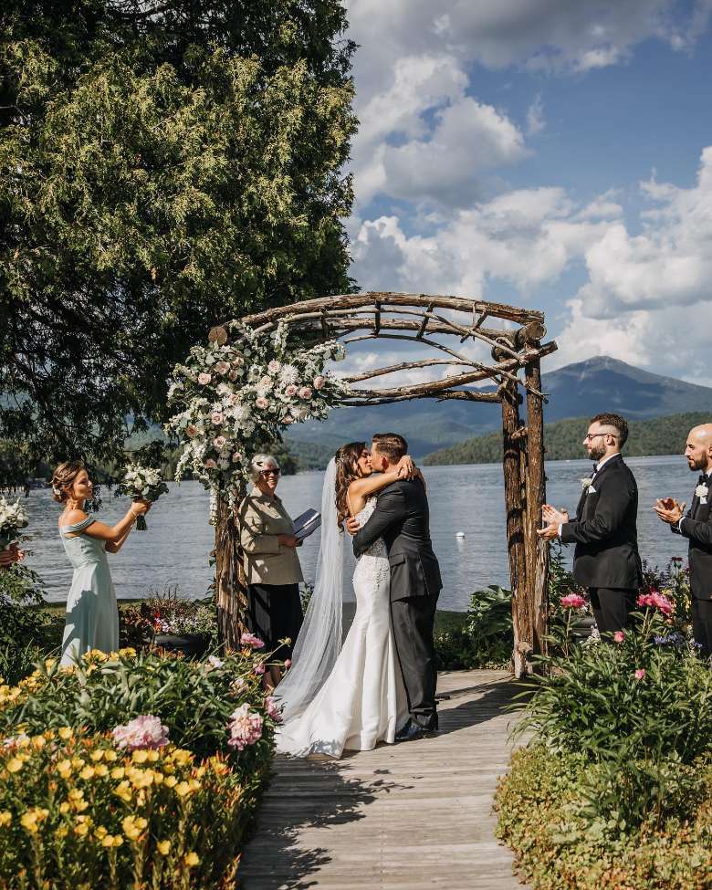 bride and groom embrace by alter at outdoor wedding