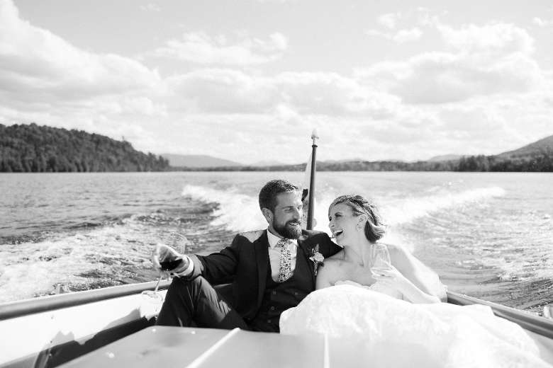 black and white photo of bride and groom on boat