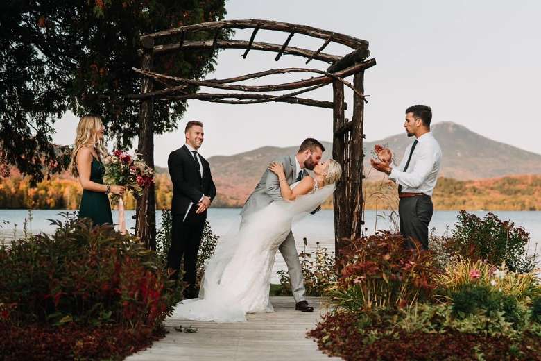 bride and groom kiss at fall wedding