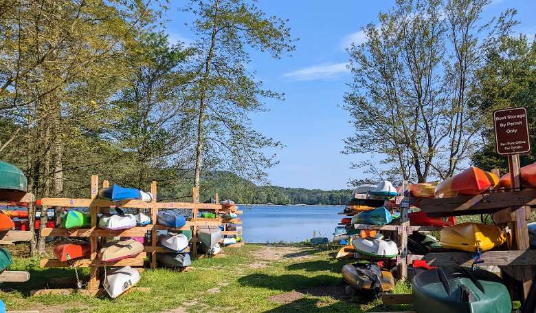 kayaks stored by lake