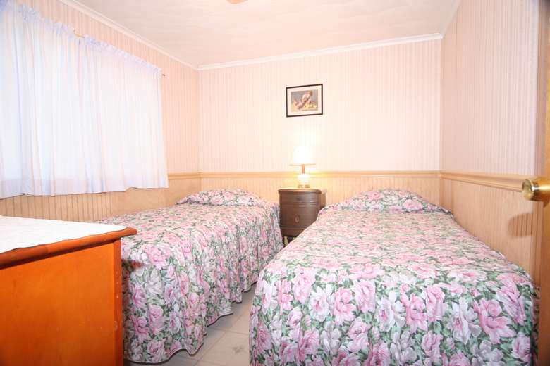 bedroom with two beds with floral blankets
