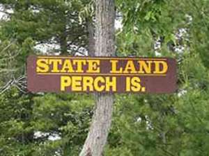 the sign for perch island up on a tree
