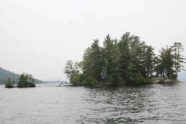 an island with trees near a smaller island with just a few trees