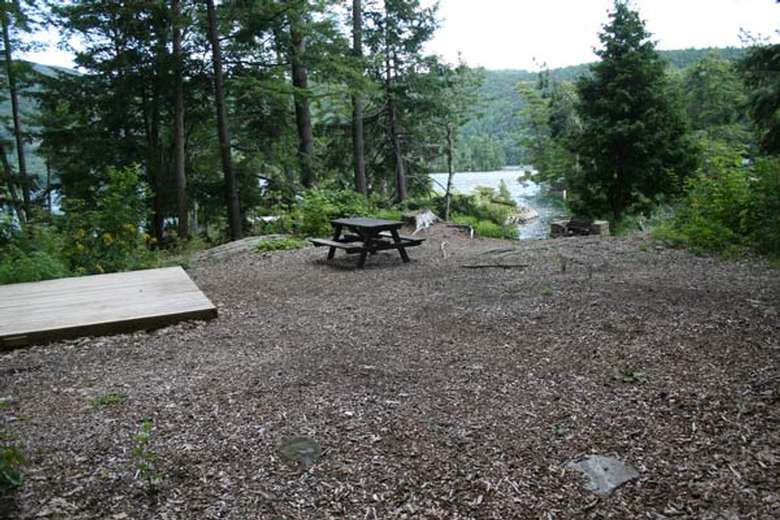 a flat area with a tent platform and a picnic table