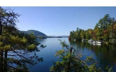 a view of the lake with a boat near the shoreline