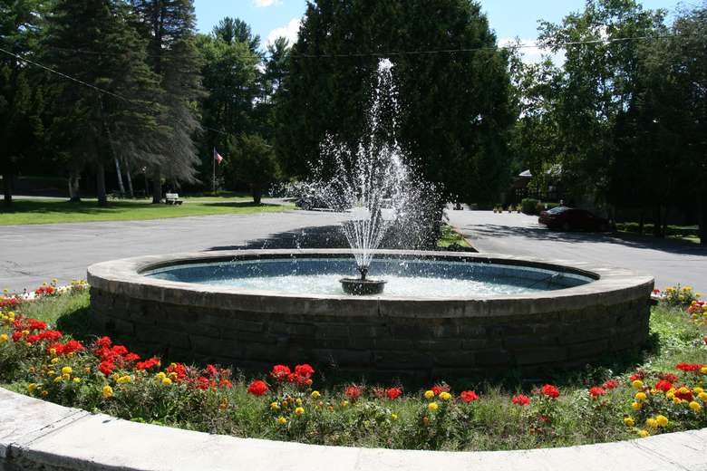 outdoor fountain near a parking lot