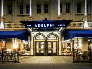 the front entrance of the adelphi hotel at night