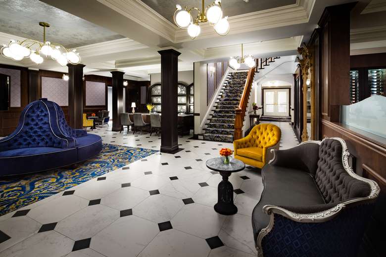 a hotel lobby area with stairs in the back