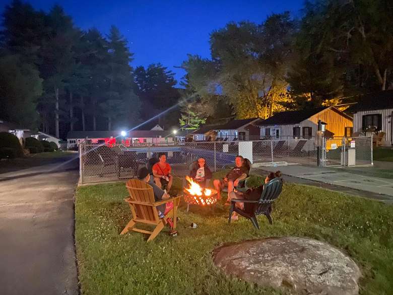 group gathered around a campfire