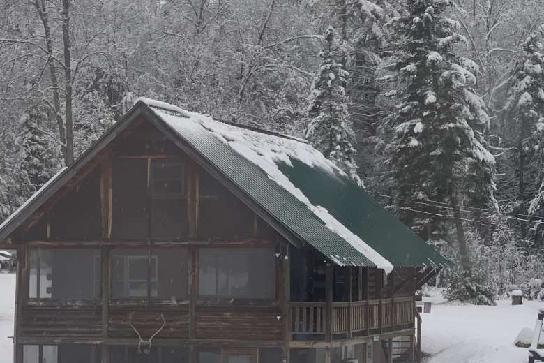 exterior of log home during snowy winter