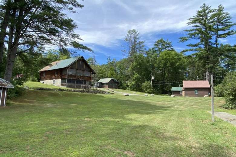 large grassy property with cabins