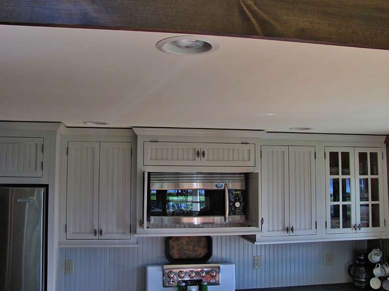 a microwave set within a row of upper cabinets