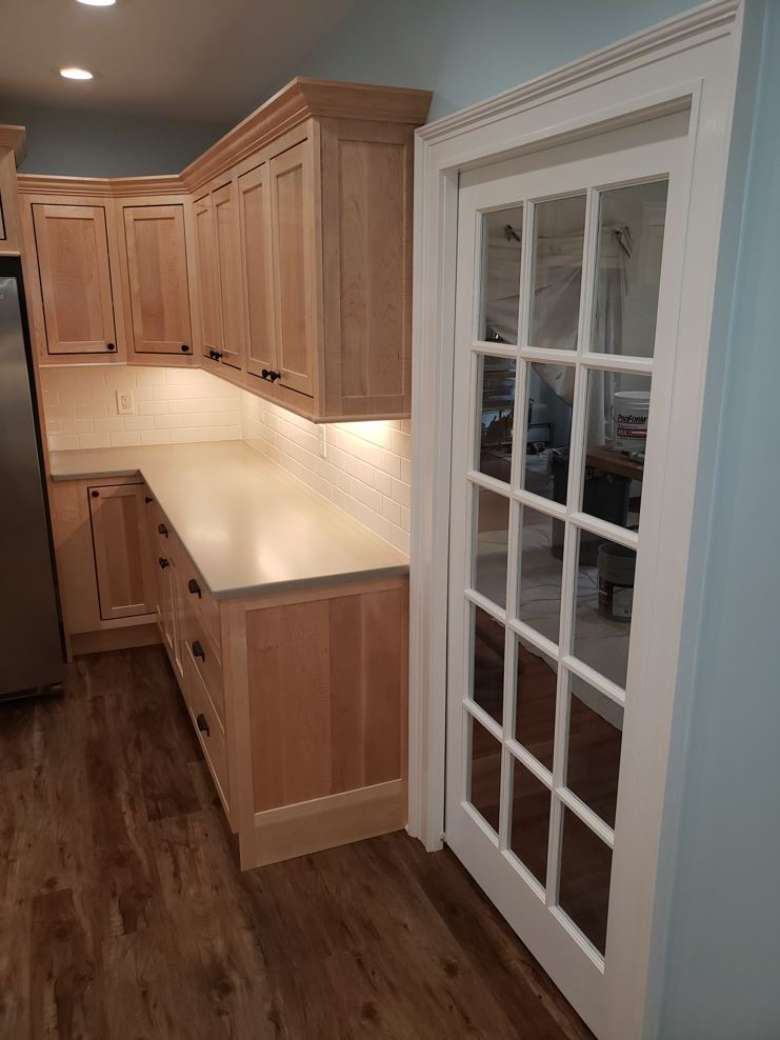 Custom installed French pocket door for this new maple kitchen