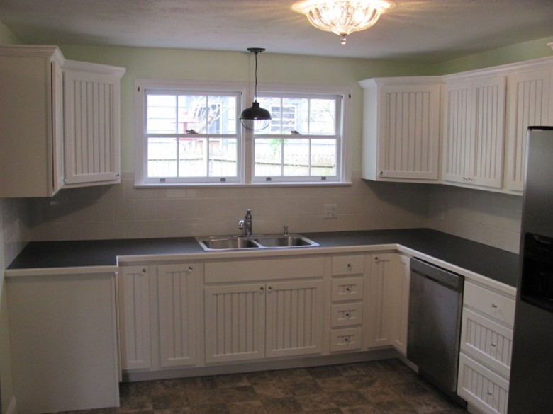 Custom made kitchen with beadboard doors and glass door knobs. 1800's Cira home