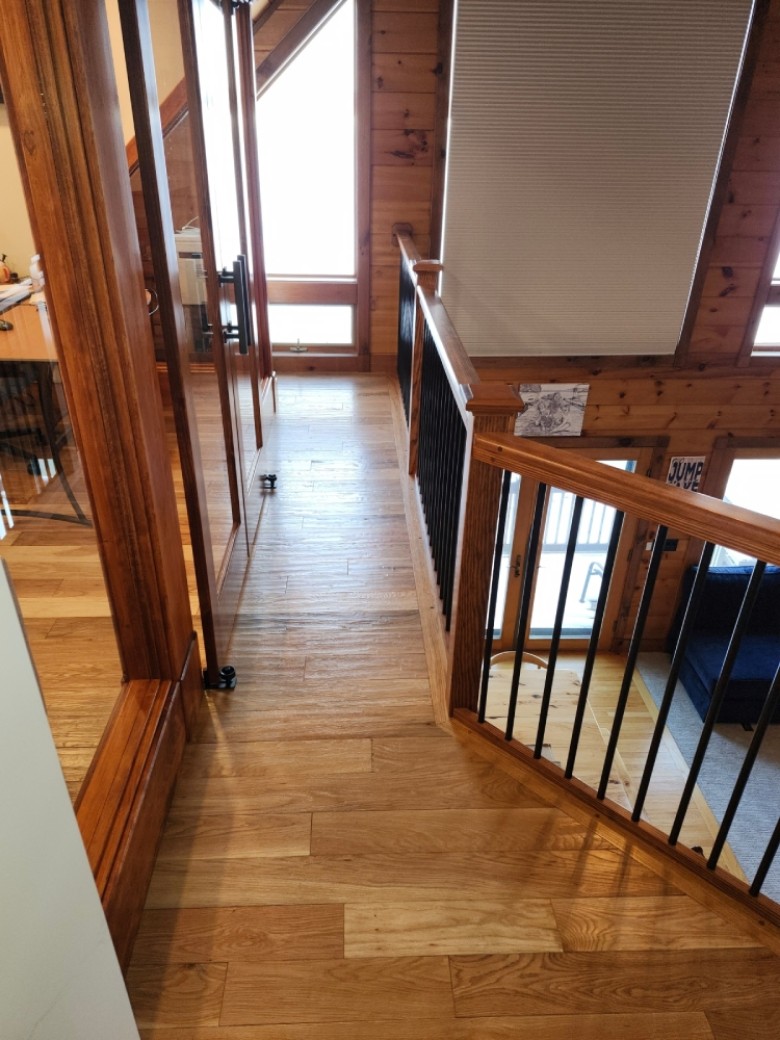 Custom made railings with hand scraped oak flooring