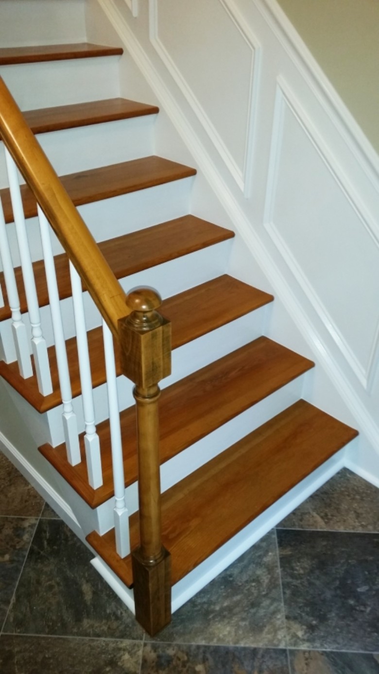 Custom stair refinishing with wainscot trim