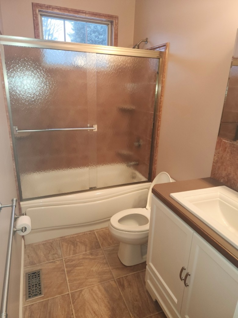 complete bathroom makeover with new custom vanity and whirlpool tub with tile surround