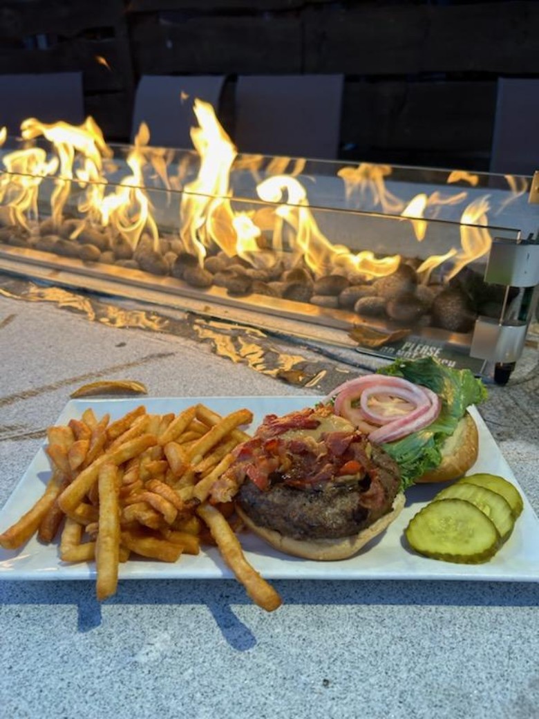 burger and fries near a patio fire