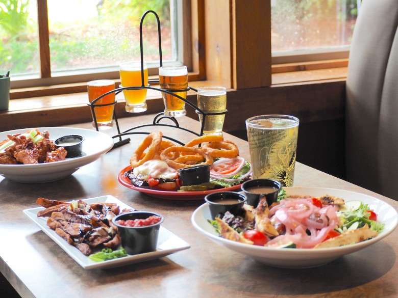salad, poutine, wings, and more on a table