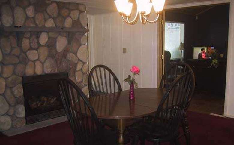 dining room with a stone fireplace