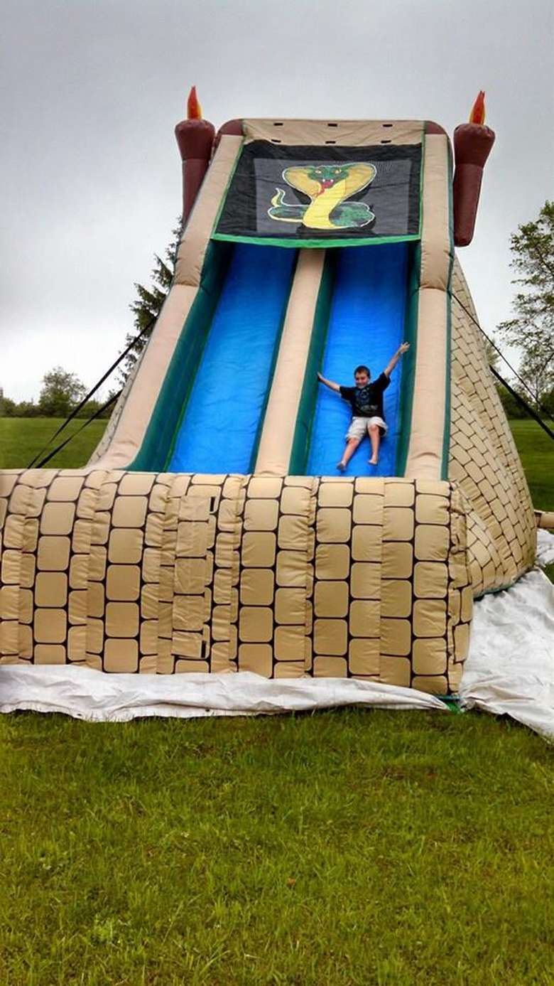 A boy sliding down an inflatable slide