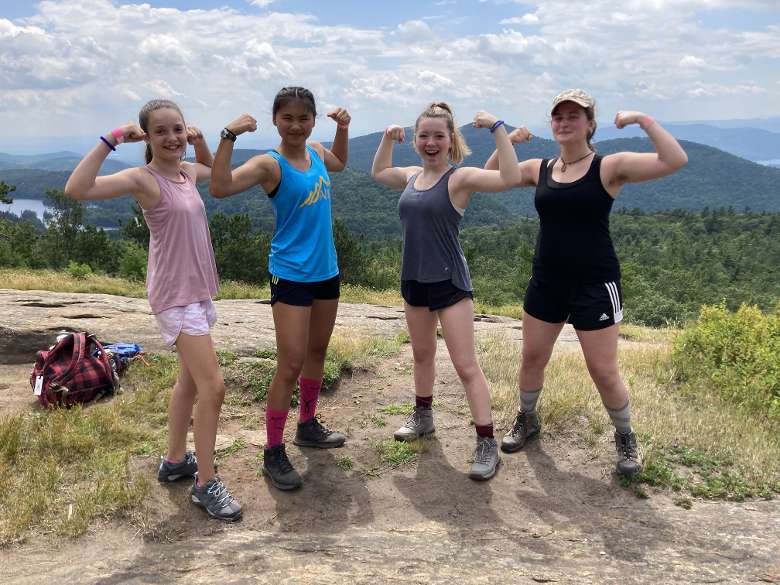 campers show off their muscles atop a mountain