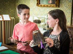 Children exploring hands-on items in the Everyday Hometown Life exhibit