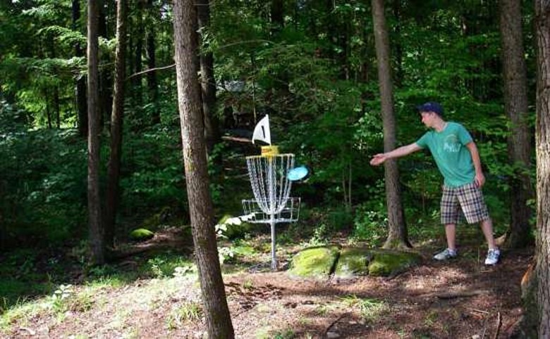 Man throwing a disk on the 18 hole disk golf course