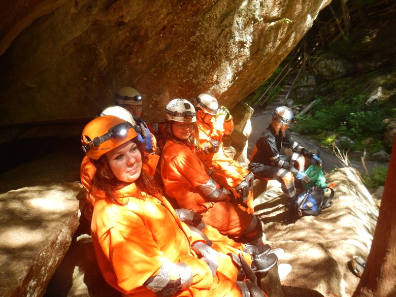 people in caving outfits