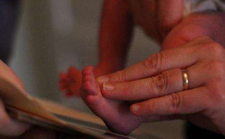 midwife printing a newborn's foot