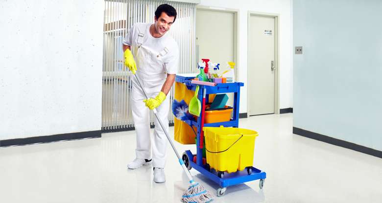a man dressed in white by a janitor's pull station