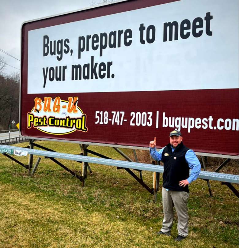 Bug- U Pest Control LLC Billboard. Our owner Brent Brewer standing in front of local ad.