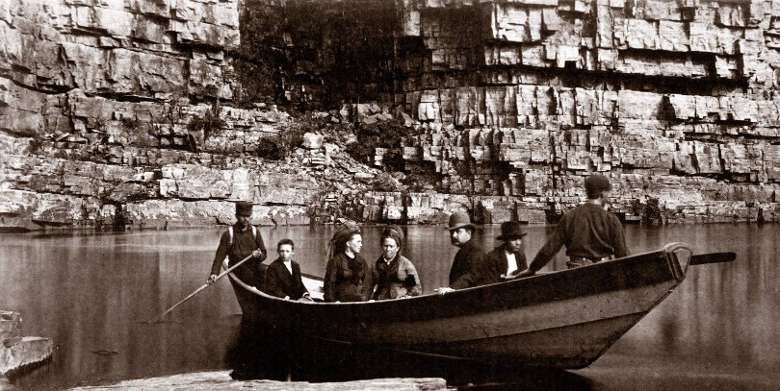 black and white photo of people on a boat