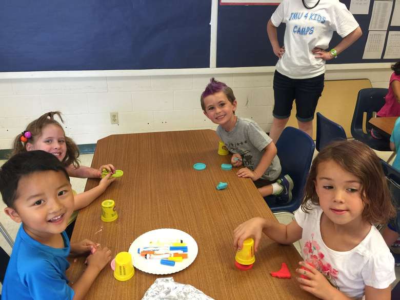 kids at a table playing with play doh