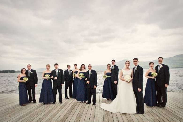 Wedding party standing on dark staggered in pairs