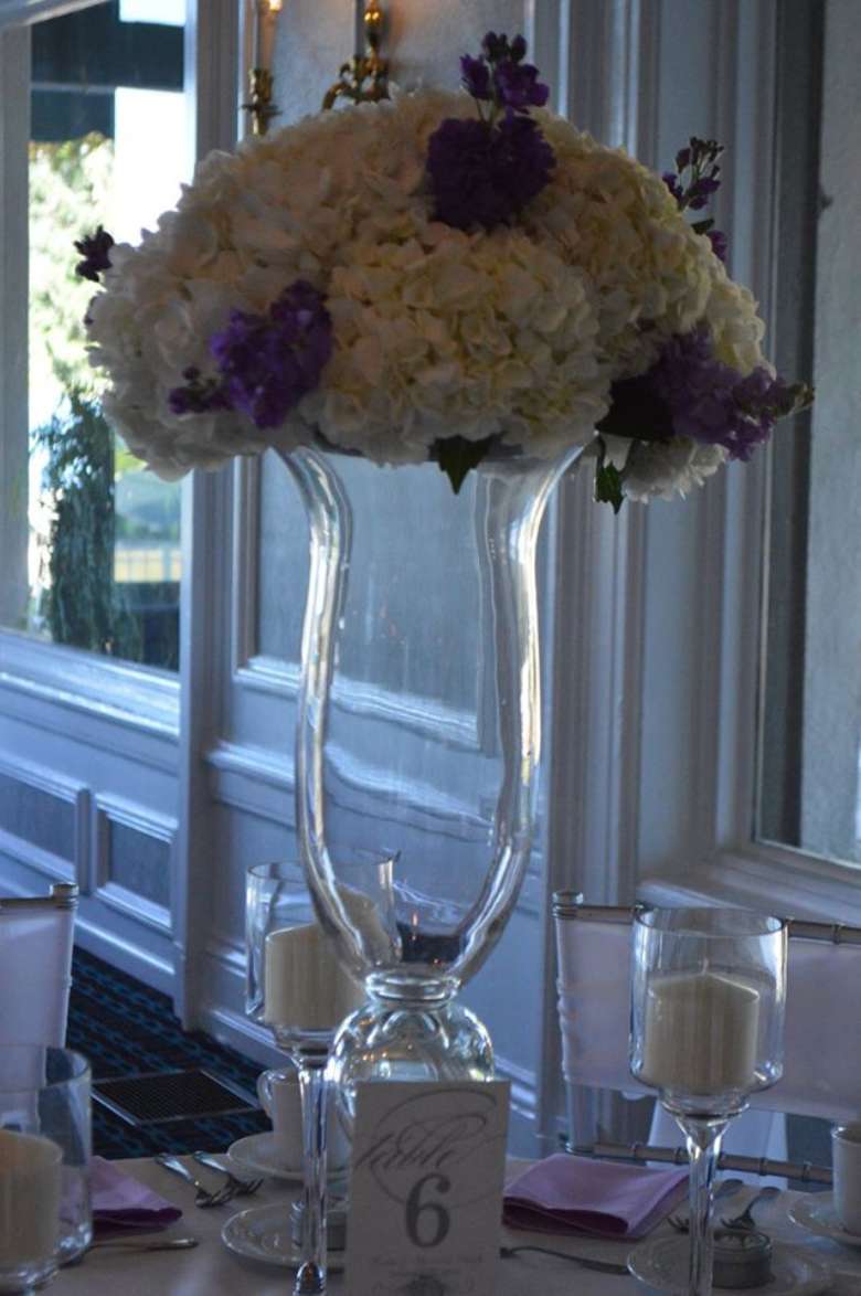 Flowers on top of large glass vase