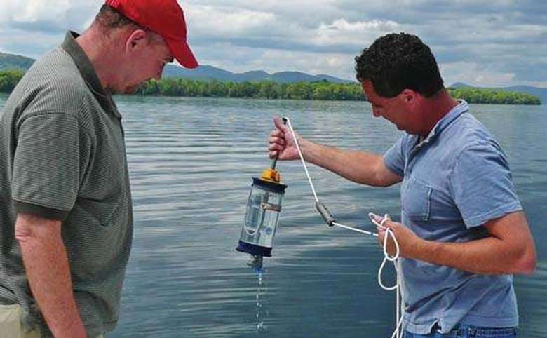 Two men examine a water quality sample
