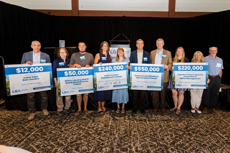 group of people holding up awards
