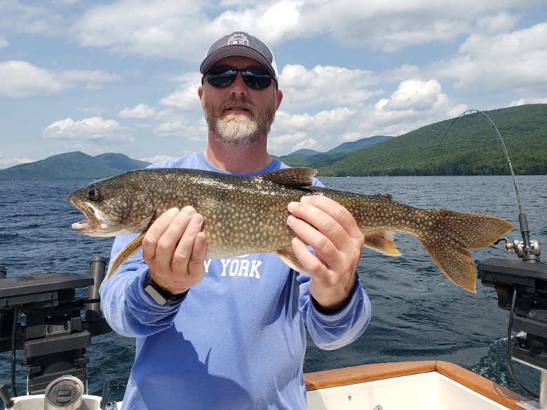 man with beard with holding fish