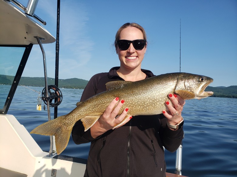 woman in glasses holding fish