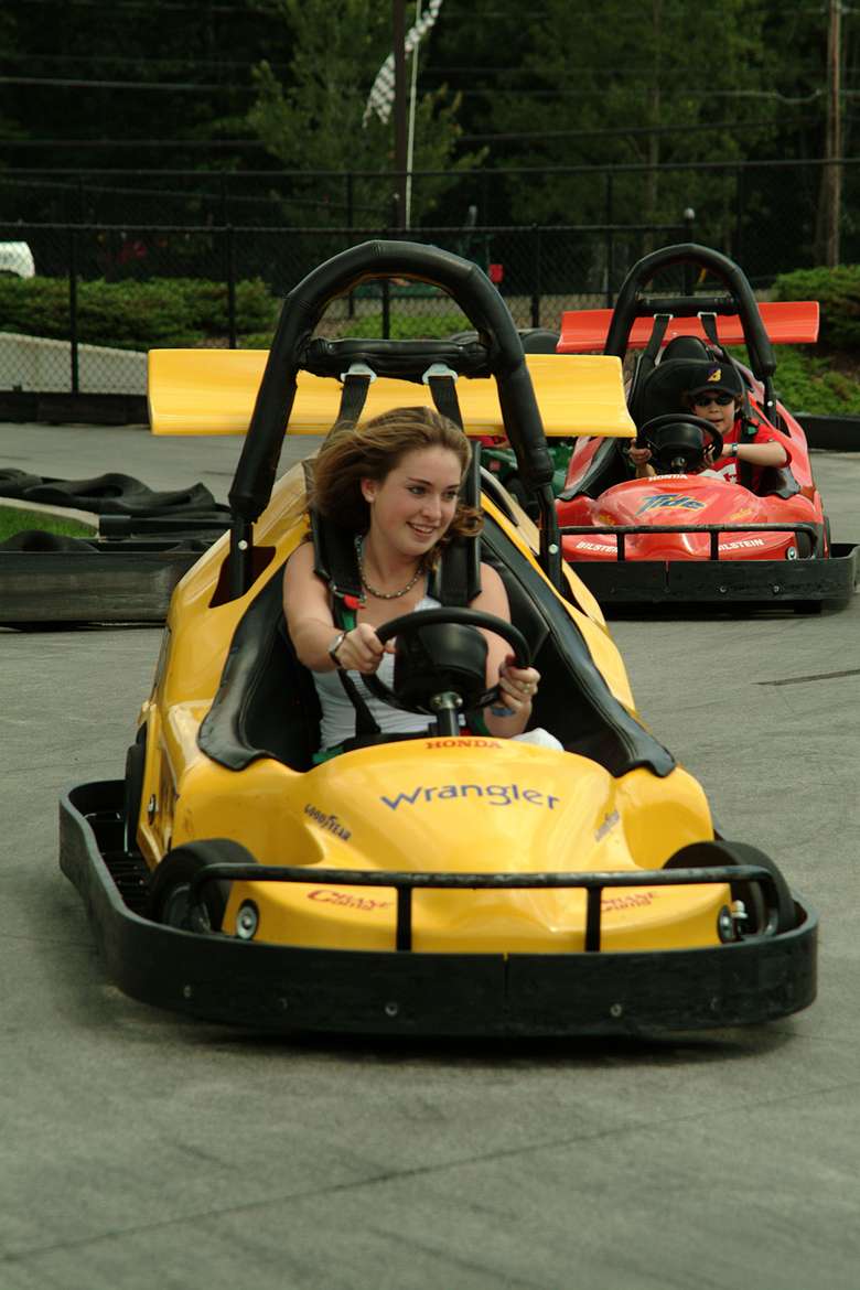 a young woman driving a go-kart