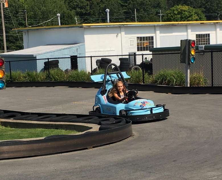 a young girl in a go-kart